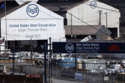 Two large white barn-shaped buildings with the U.S. Steel logo are shown.