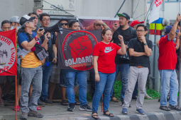 Filipino workers rally outside Kawasaki Motors.