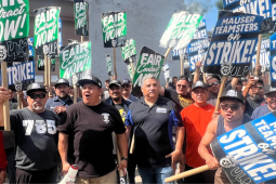Workers hold signs reading "fair contract now" and "Mauser Teamsters on Strike"
