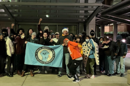 Amazon workers and community supports gather holding an Amazon CAUSE banner. 