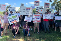 Dozens of Blizzard workers and supporters hold signs outside the Blizzard headquarters in Irvine, California.