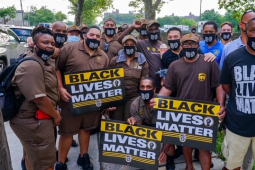 crowd of workers, many in brown UPS uniforms, with "Black Lives Matter" signs