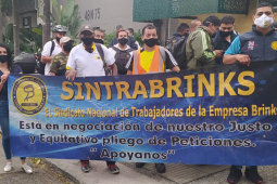 Sintrabrinks workers picketing behind a blue banner in Cali, Colombia in December 2020.
