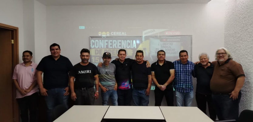 Former Honda workers gather for a photo at a press conference. 