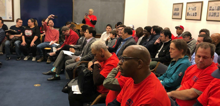Meeting of DASH drivers, most of them seated and wearing red.