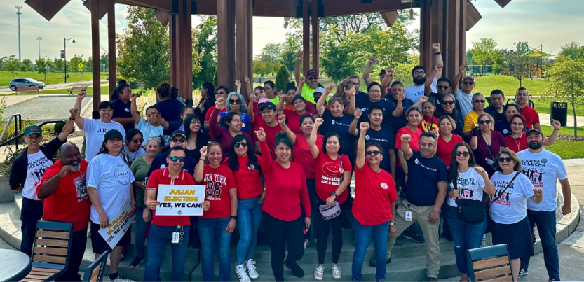 Workers and allies hold pro-union signs and raise their fists in a show of collective power. 