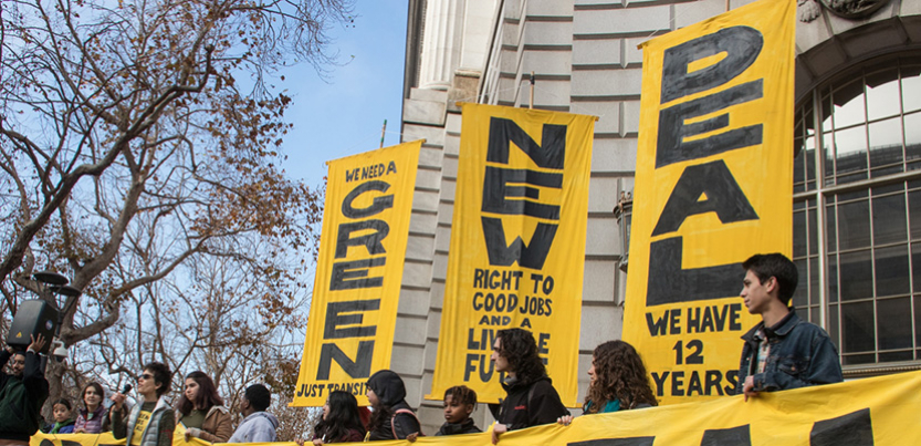 Green New Deal banners at rally