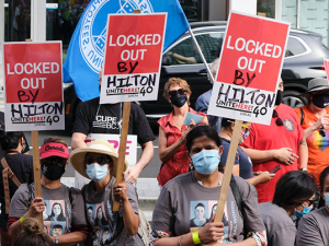 Hilton Vancouver Metrotown workers with signs fighting for their recall rights.