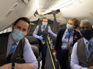 Four Association of Flight Attendants members wear masks on an Alaska Airlines flight.