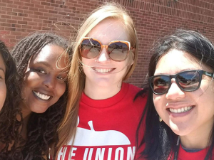 Selfie of four Baltimore teachers in front of a school.