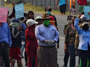 Group of protesters in Honduras assembled in the street with signs