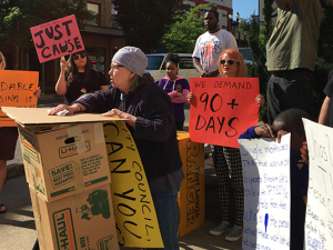 Housing rights protesters protesting with signs.