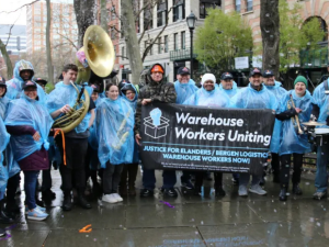 Bergen logistics workers and supporters gather in blue rain ponchos. 