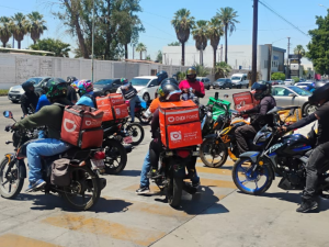 Workers stand by on their motorcycles. 