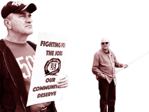 Two UE picketers, one with a sign and the other with a flag.