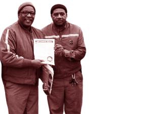 Two UPS workers holding a document.