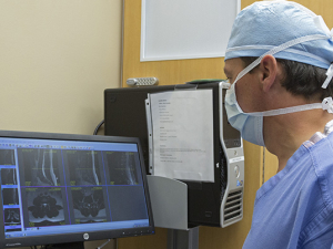 Doctor views imaging machine