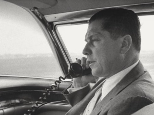 The late Teamsters president Jimmy Hoffa talking on the phone in a car.