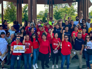 Workers and allies hold pro-union signs and raise their fists in a show of collective power. 