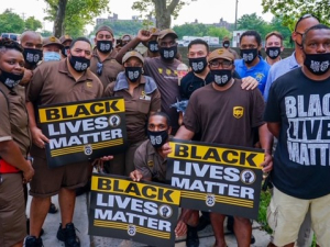 crowd of workers, many in brown UPS uniforms, with "Black Lives Matter" signs