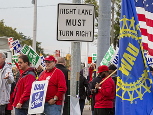 UAW strikers picketing on a street corner.