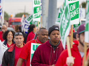 UAW workers marching with picket signs.