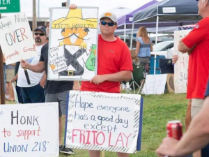 Frito-Lay workers hold signs on the picket line.