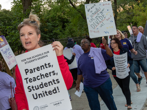 Chicago teachers and Service Employees (SEIU) Local 73 marching with signs.