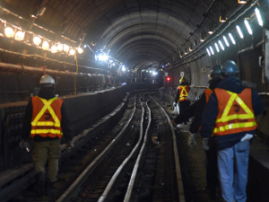 New York City transit workers working in a subway tunnel in 2017.