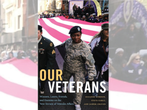 Book cover of “Our Veterans” shows a black woman veteran in a parade carrying the edge of a huge American flag with other marchers.