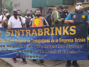 Sintrabrinks workers picketing behind a blue banner in Cali, Colombia in December 2020.