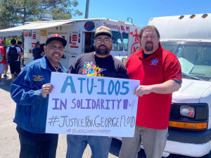 Three men (two Black, one white) hold a sign: "ATU-1005 in solidarity w/ #JusticeForGeorgeFloyd #BlackLivesMatter." Taco truck in background.