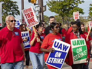 Crowd of GM workers on strike, marching.