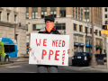 CWA protester holding a sign that says "We Need PPE"