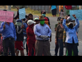 Group of protesters in Honduras assembled in the street with signs