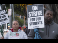 A white man and a Black man hold signs: "On Strike for Our Students; UTLA"