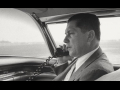 The late Teamsters president Jimmy Hoffa talking on the phone in a car.