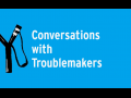 Black slingshot on blue background with text "Conversations with Troublemakers"