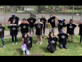 Duke University Press Workers Union posing in matching black T-shirts on grass.