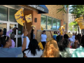 Workers with flags gather outside the glass-doored offices of Frontline in Cleveland