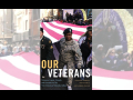 Book cover of “Our Veterans” shows a black woman veteran in a parade carrying the edge of a huge American flag with other marchers.