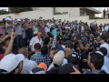 Crowd of teachers and supporters protesting in Amman in front of building, some with raised arms, on July 29 2020