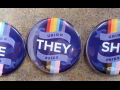 Three purple buttons. Pronoun "He," "They," or "She" is surrounded on each button by rainbow flag, trans flag, and the words "Union Pride."