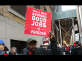 A striking worker holds a sign saying "CWA and IBEW Demand Good Jobs at Verizon" during the 2016 Verizon strike.