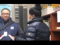 Two postal workers talking to each other inside an office.