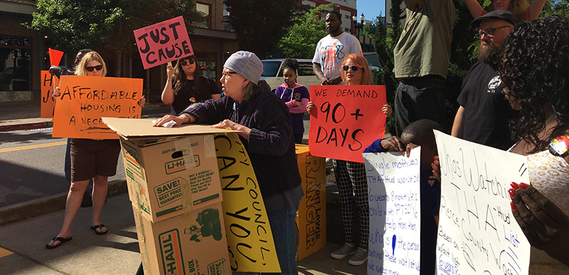 Housing rights protesters protesting with signs.