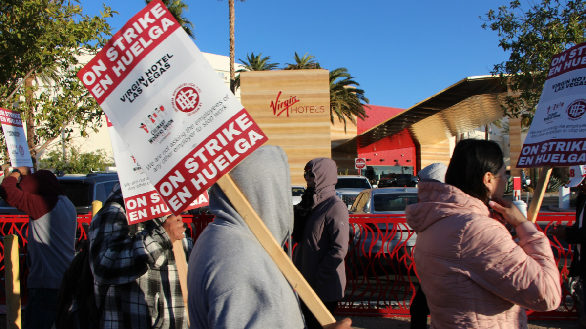 Workers picket outside the hotel. 