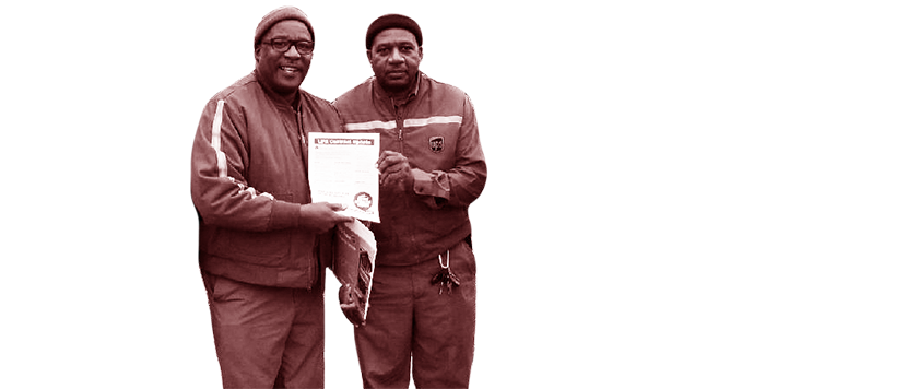 Two UPS workers holding a document.