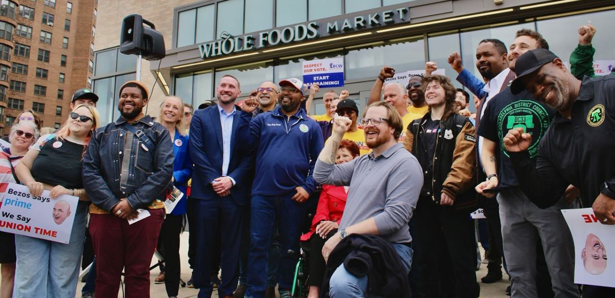 Workers and union supporters stand in front of the Philadelphia Center City Whole Foods.