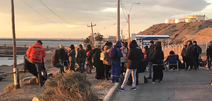 Chubut workers gathering by the side of the road.